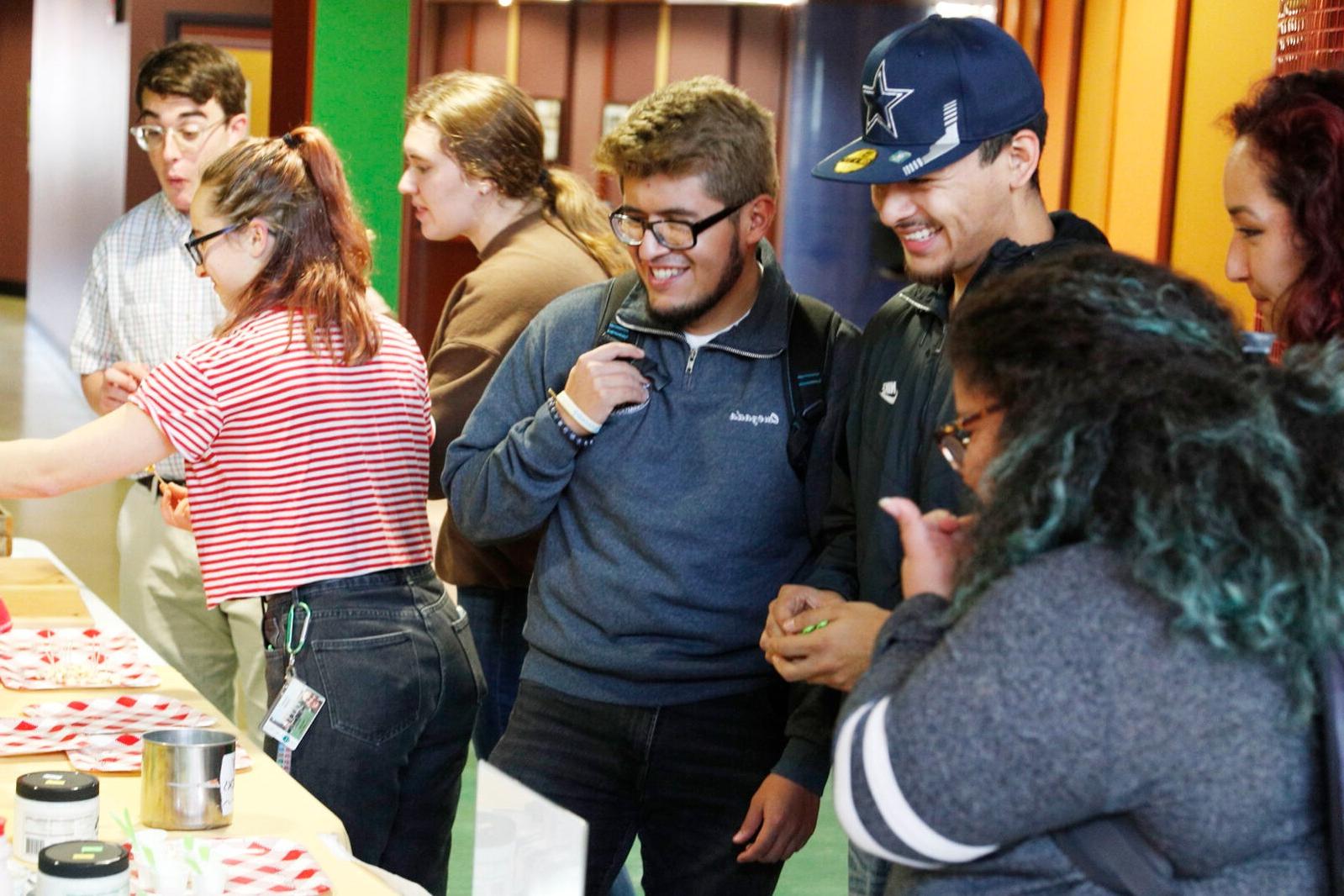 Students+enjoy+samples+from+local+vendors+at+a+farmers+market-themed+dinner.